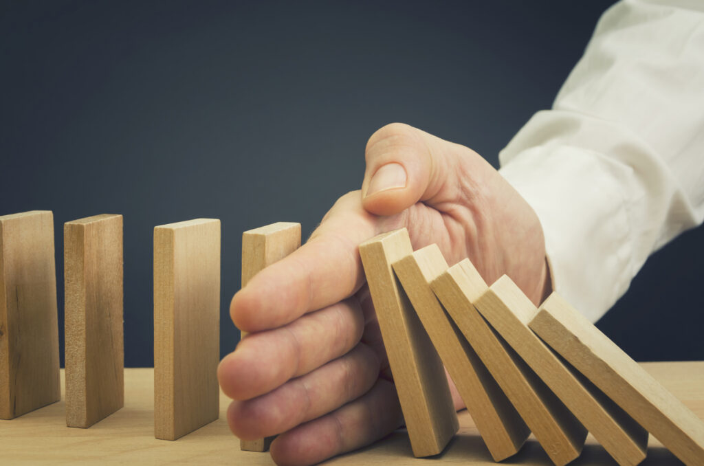 Businessman Stop Domino Effect